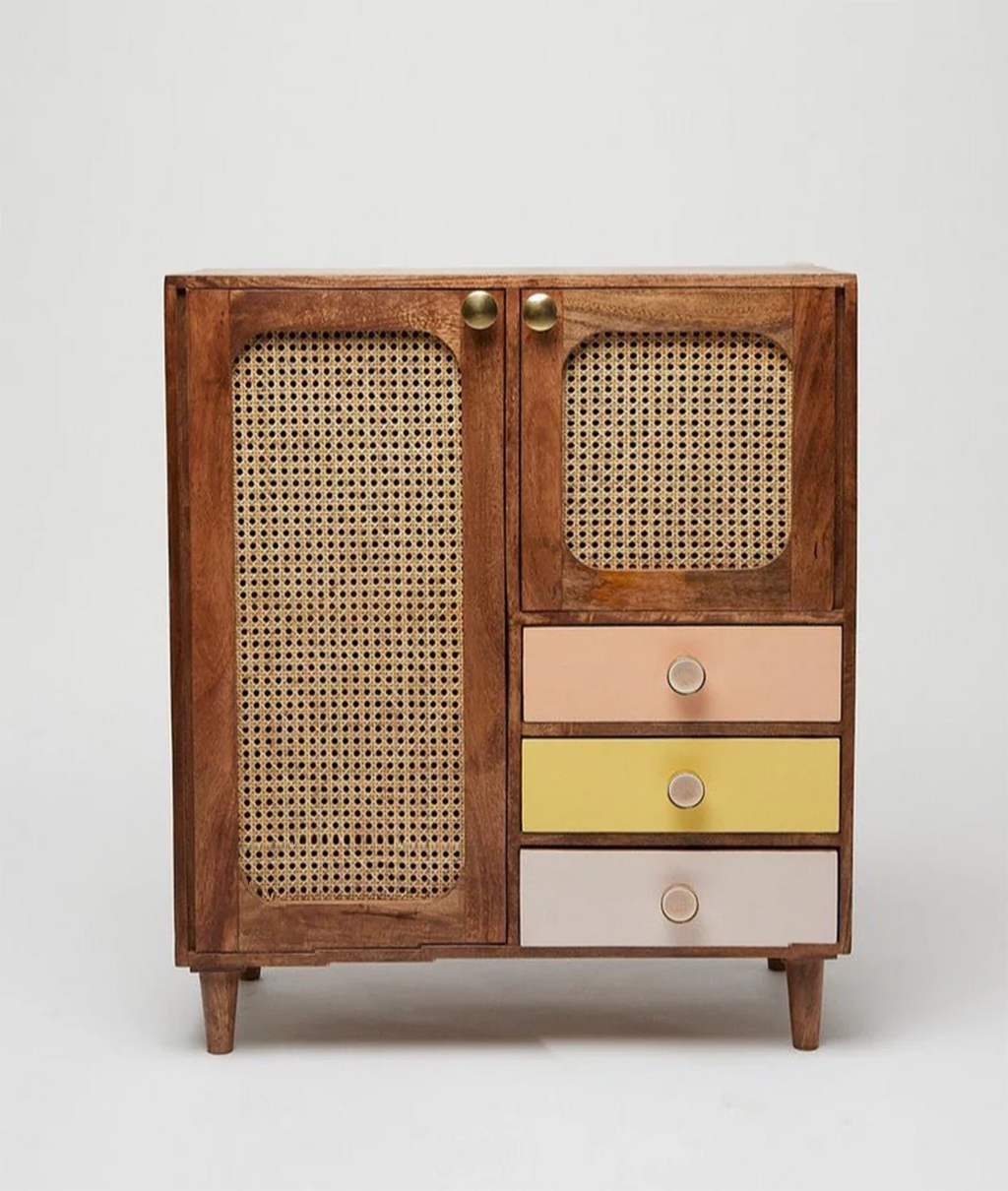 Wooden cabinet with wicker doors and colorful drawers on a white background